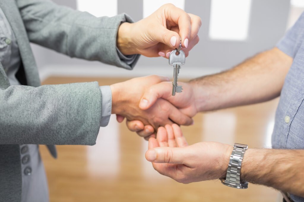close up of a man receiving a handshake and a key 2026 04 14 00 00 04 utc